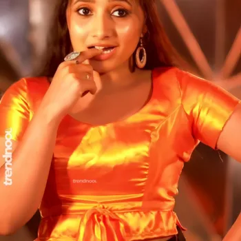 Krishna Shilpa orange satin crop top